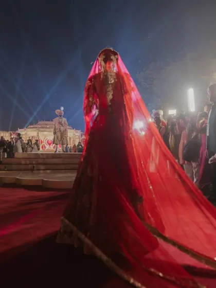 A moment of anticipation before the union. The bride's walk to the stage, veiled in red, is a timeless tradition I love to frame with dramatic lighting and a clear path, focusing all attention on her graceful approach.