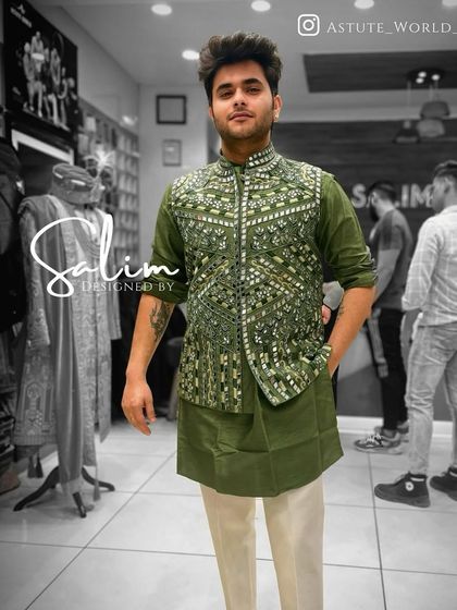 A client in an olive green kurta paired with a matching Nehru jacket that is heavily embellished with mirror work. A great look for a sangeet or festive party.