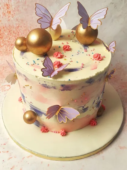 Another angle of the pastel butterfly cake, showing the interplay of pink, purple, and blue hues.