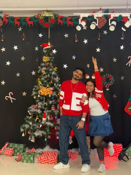 Posing with my partner in our festive outfits. The holiday season is all about joy, love, and of course, dancing.