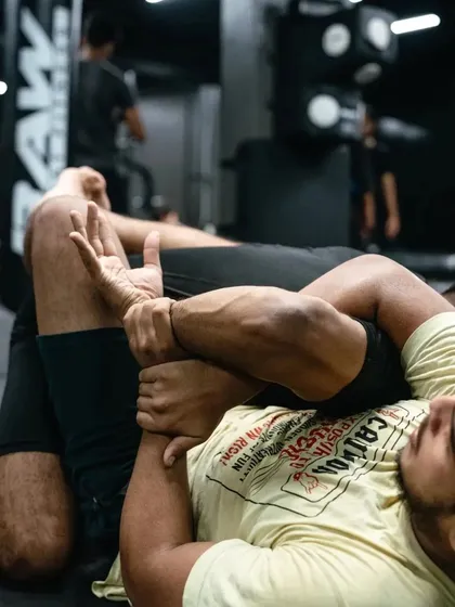 A close-up on the grips and control during a Jiu-Jitsu roll, highlighting the technical details.