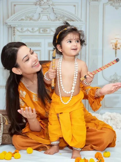 A mother and child interact during a Krishna-themed shoot. These sessions are designed to be fun and engaging for the little ones.