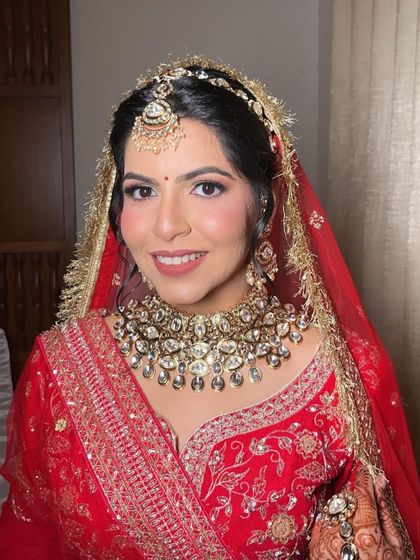 My bride Ankita, looking like an absolute stunner for her wedding. We went for a classic look with a bold lip that perfectly matched her red lehenga.