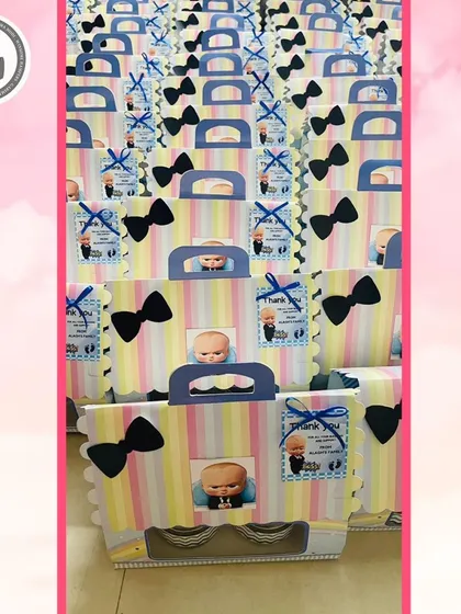 A large batch of my Boss Baby themed return gift bags. The pastel stripes and bow tie detail make them a stylish and fun party favor.