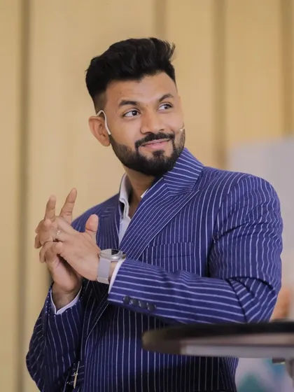 A client commanding the stage in our custom-made blue pinstripe suit. The fit is tailored to allow for movement and presence, proving that bespoke is the ultimate choice for professionals.
