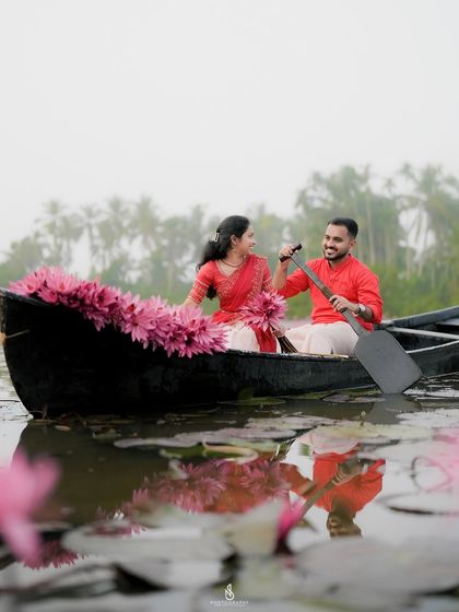 A playful moment as he paddles the boat through the lily pond. This image tells a story of a shared, joyful experience.