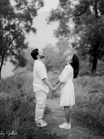 Holding hands and looking up at the sky together. This black and white shot is full of hope and shared dreams, a beautiful moment from Nutan and Shubham's pre-wedding shoot.