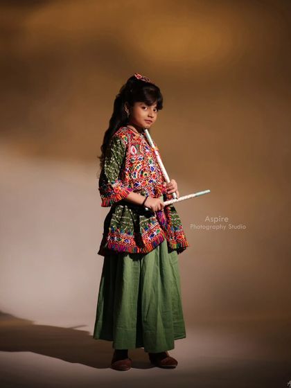 A more direct and playful portrait in her traditional attire. This image captures her bright personality and is a wonderful addition to a diverse child model portfolio.