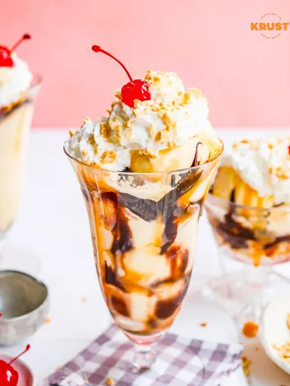 A classic ice cream sundae, complete with whipped cream, sauce, and a cherry on top. This is the kind of indulgent treat you can build in our sundae workshop.