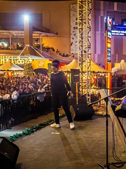 On stage at Phoenix Marketcity, with a huge crowd gathered in the open-air venue. This shows our experience in handling large-scale public events and turning a shopping plaza into a concert arena.