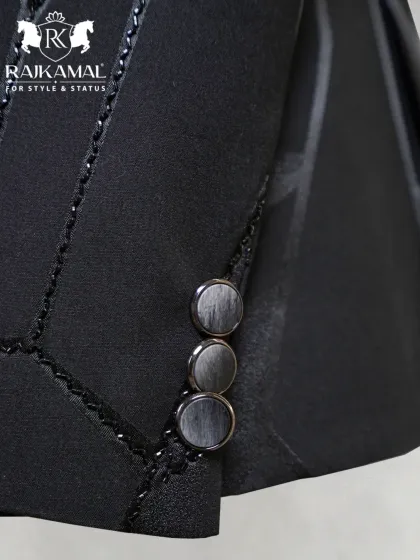 A detail shot of the sleeve cuffs on the black geometric Jodhpuri, highlighting the custom buttons and fine stitching.