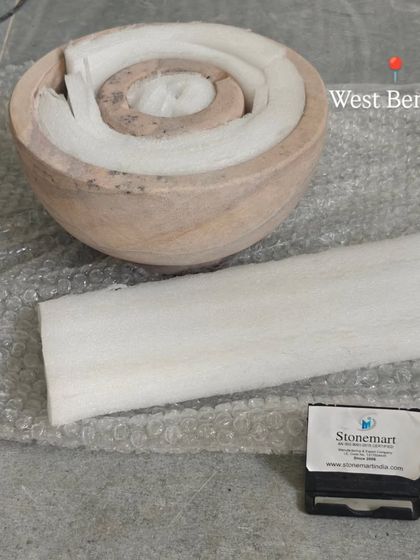 The components of a rainbow stone fountain, including the bowl and sphere, are individually wrapped in foam before being packed.