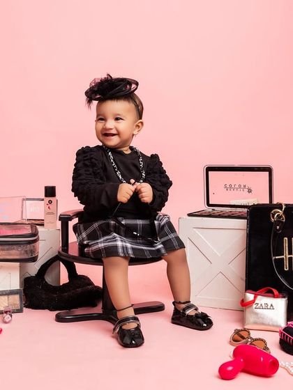 A big, happy smile surrounded by all things glam. This setup is perfect for parents who want a unique and stylish way to celebrate their baby's first year.