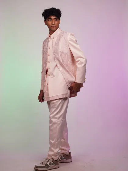 A side view of the pastel pink Indo-Western set, highlighting its unique layered construction and modern silhouette.