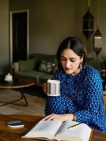 A quiet moment of an author with her book. This portrait of Aanchal Malhotra for Patrika Gift Shop captures her in a natural, thoughtful pose, creating an authentic image of a writer at work.