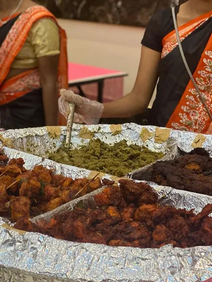 A close-up of our assorted non-vegetarian starters, a crowd favorite at wedding receptions. This platter features a variety of kebabs and fried items, each seasoned and cooked to perfection by our expert chefs.