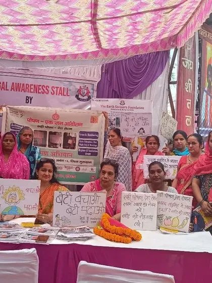Women from the community displaying handmade posters against domestic violence at our legal awareness stall. It was a powerful moment of solidarity and a testament to the impact of our outreach.