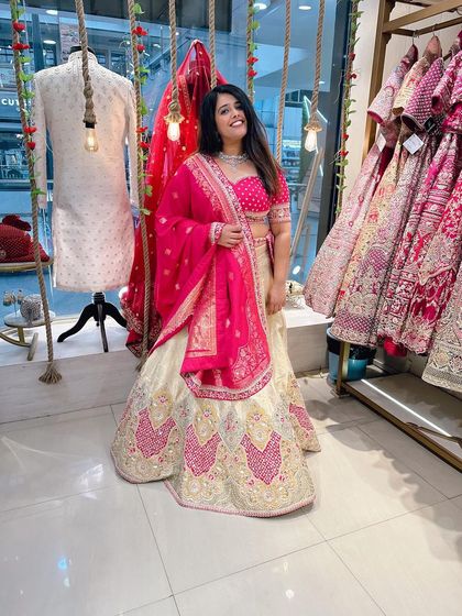 Posing in front of the store's decor, this client is glowing in her chosen lehenga. It's a perfect fit and a perfect look.