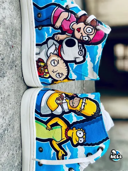 A top-down view of the cartoon mashup sneakers, showing how the characters from both shows are laid out across the canvas.