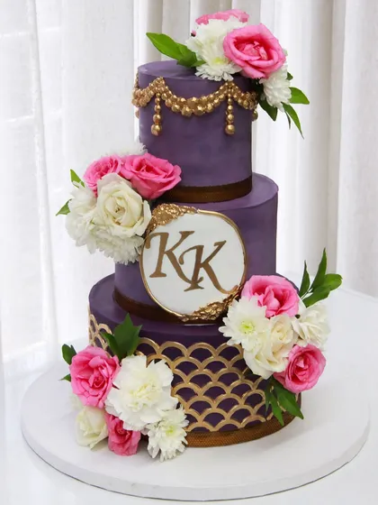 A repeat of one of my favorite designs for a wedding cake, this time in a royal purple. This three-tiered cake is covered in my signature colored ganache and adorned with fresh flowers and a custom monogram.