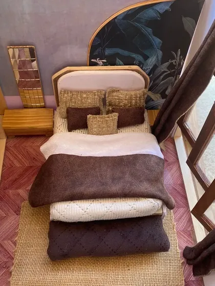 Before a single piece of full-size furniture is built, a detailed scale model can bring an interior design concept to life. This miniature bedroom prototype helps visualize space, texture, and layout in a tangible way.