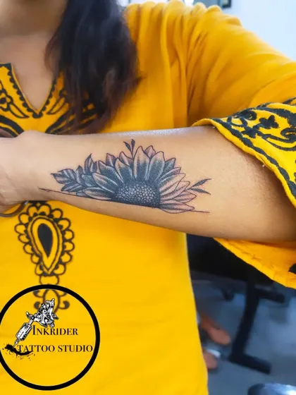 Another example of a sunflower cover-up, this time on the forearm. We can adapt popular designs to fit the size and shape of the tattoo you want to hide.