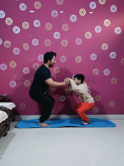 Teaching a young student the basics of a bodyweight squat. It's never too early to learn about health and fitness.