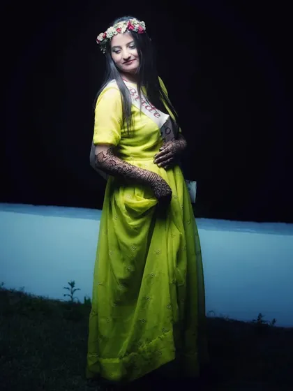 A candid outdoor shot of the bride during her mehendi photoshoot. The natural pose and her gentle smile make for a timeless and beautiful photograph.