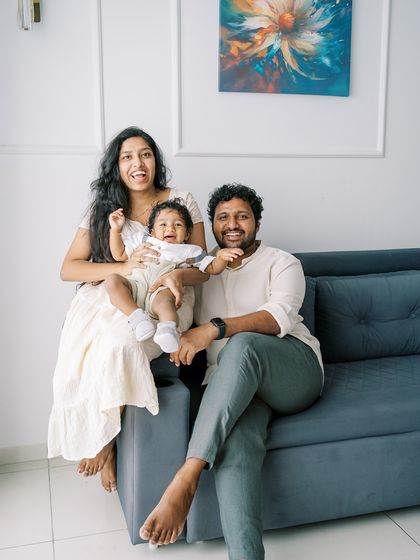 A happy family portrait on the sofa. The laughter and joy are what make this photo so special.