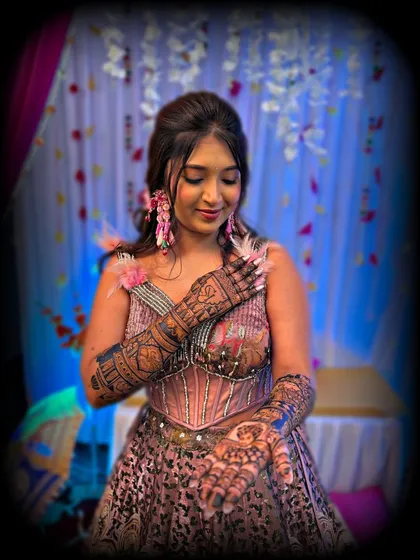 A lovely, candid shot of a bride admiring her beautiful mehndi. The design features a unique cityscape on the back of her hands.