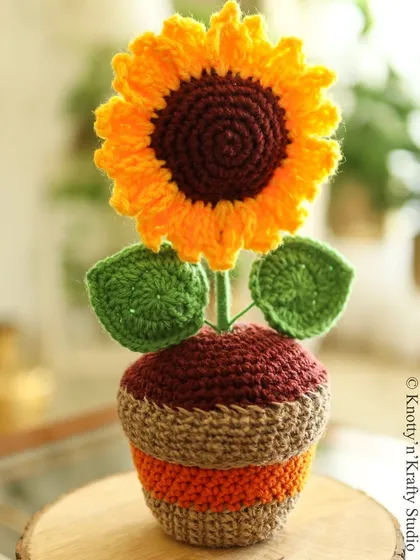 A handmade sunflower to bring a little bit of everlasting sunshine indoors. This potted crochet flower is a cheerful desk buddy or a bright accent for a shelf, adding a pop of color that never fades.