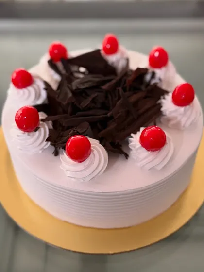 My take on the classic Black Forest cake, with whipped cream, chocolate shavings, and bright red cherries.