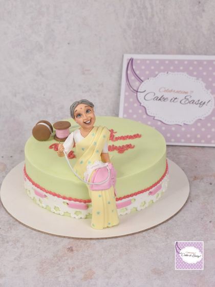 A different angle of the sewing-themed cake, showing the delicate lace detail.