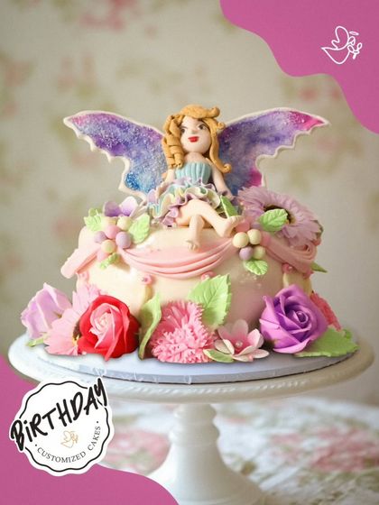 A whimsical fairy cake, featuring a delicate fairy with sparkling wings sitting atop a garden of handcrafted sugar flowers. This enchanting design is perfect for a magical birthday celebration.