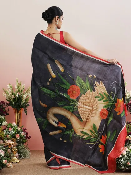A beautiful saree featuring a hand-painted style swan on the pallu, surrounded by floral motifs.