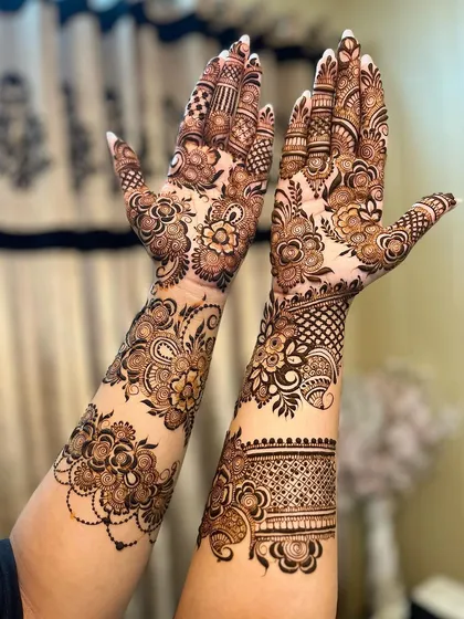 A dynamic shot of the floral mehandi, showing how it adorns the hands and arms.