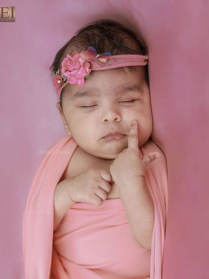 An adorable close-up where the baby is touching her own cheek. These unposed, natural movements are precious to capture.