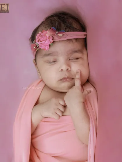 An adorable close-up where the baby is touching her own cheek. These unposed, natural movements are precious to capture.
