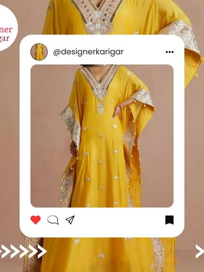 A bright yellow kaftan with silver mirror work along the borders and neckline, offering a festive and modern look.
