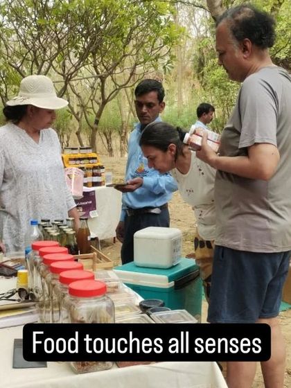 A customer smelling a product before buying, highlighting the sensory experience of shopping here.
