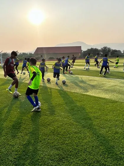 An action shot from a training match during our camp, with the morning sun creating long shadows on the pitch. It showcases the high-energy start to a day of elite training.