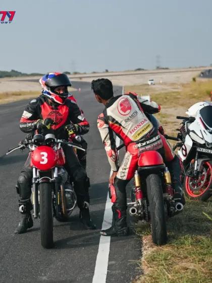 A coach giving feedback to a student on the track. This direct interaction is where real improvement happens.