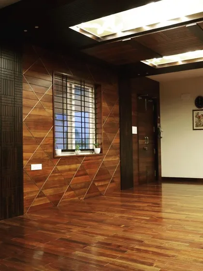 The main office area at Overseas Traders showcases extensive use of wood on the walls and floors. The geometric patterns in the paneling add a layer of design sophistication to the corporate environment.