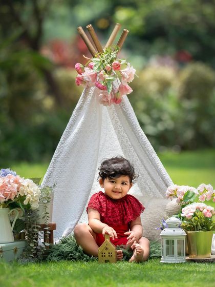 A full view of the teepee picnic setup in a beautiful garden. It's a perfect theme for an outdoor sitter session.