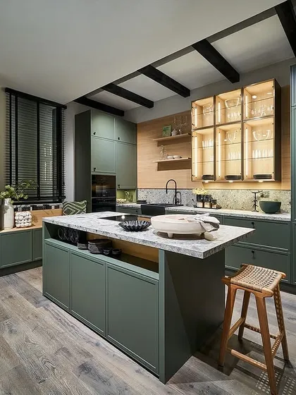 Another vibrant pick from our 2025 novelties, this kitchen in eucalyptus green features smart storage niches and a central island, bringing the essence of nature indoors.