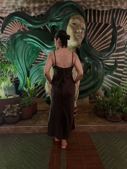 A back view of my brown dress and red heels look. Today is the occasion, so wear the bold heel and step into the dress.