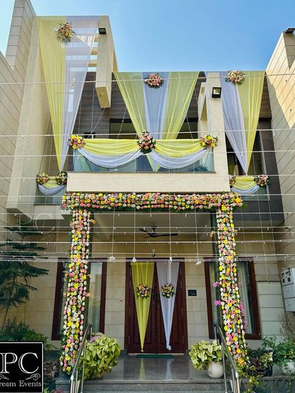 A straight-on view of the elegant home decor, showing the beautiful swag drapes on the balcony and the floral garlands framing the entrance.
