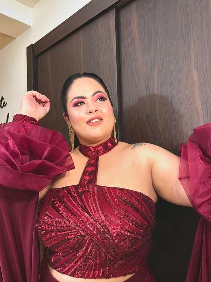 Can't nobody tell me nothing. A close-up shot of a client feeling confident and beautiful in her custom maroon sequined top.