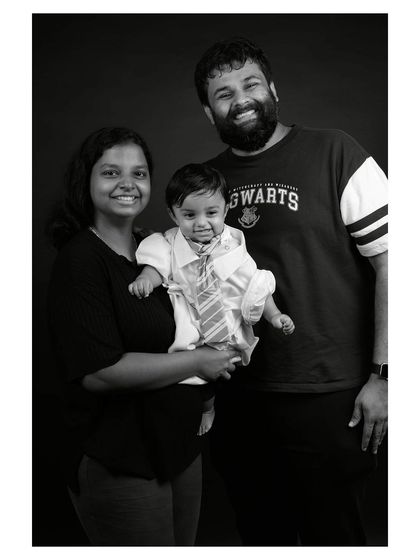 A happy family studio portrait in black and white. The simple background and classic edit make this a perfect timeless family photo.