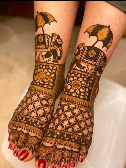 A unique and playful foot design featuring decorated elephants holding umbrellas, a symbol of royalty and celebration, perfect for a fun-loving bride.